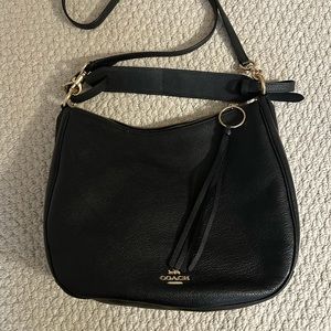Coach black leather bag with crossbody strap.
